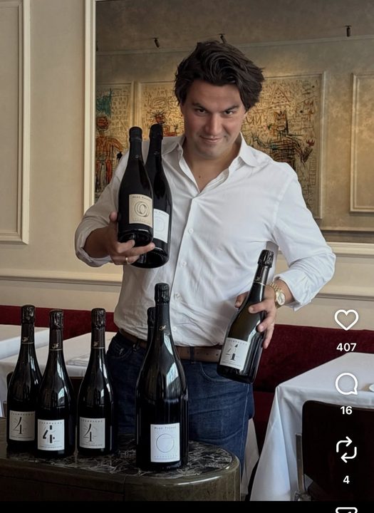 Ronan Duchêne Le May of Le Chêne holding up bottles of Huré Frères Mémoire and 4 Éléments