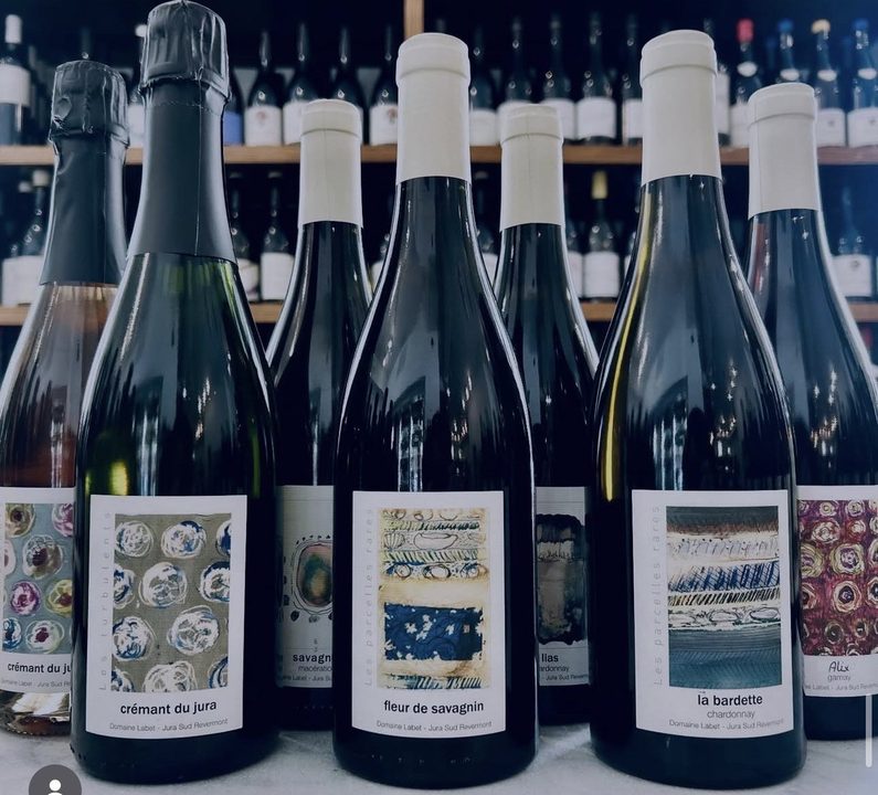 Domaine Labet bottles with their painted labels: crémant, fleur de savagnin, la bardette