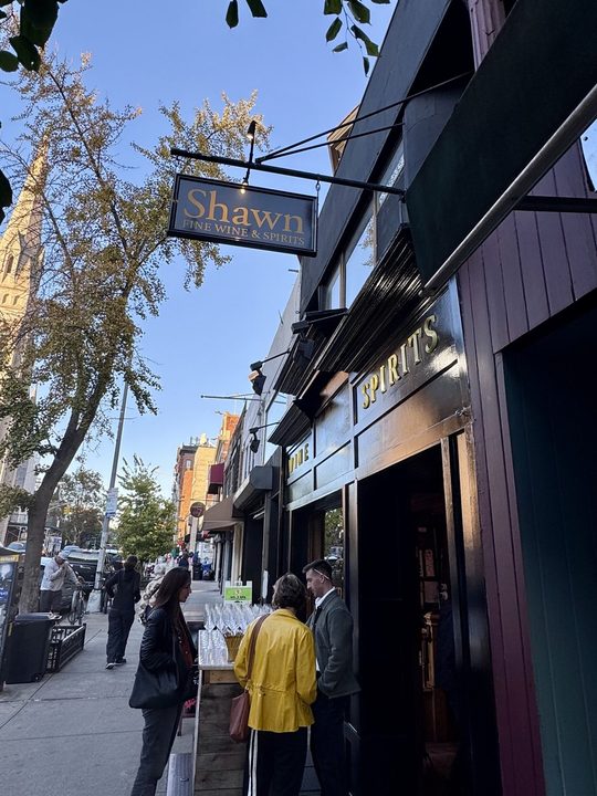 The Shawn Fine Wine & Spirits sign on Fifth Avenue, Park Slope, glasses set out on the sidewalk