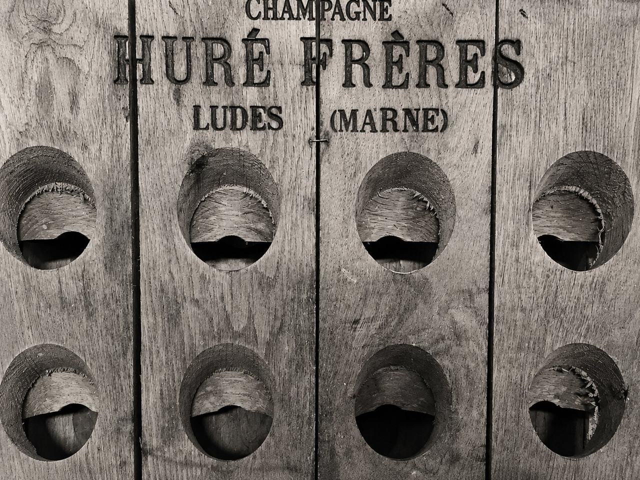 An old wooden riddling rack branded Champagne Huré Frères, Ludes (Marne)