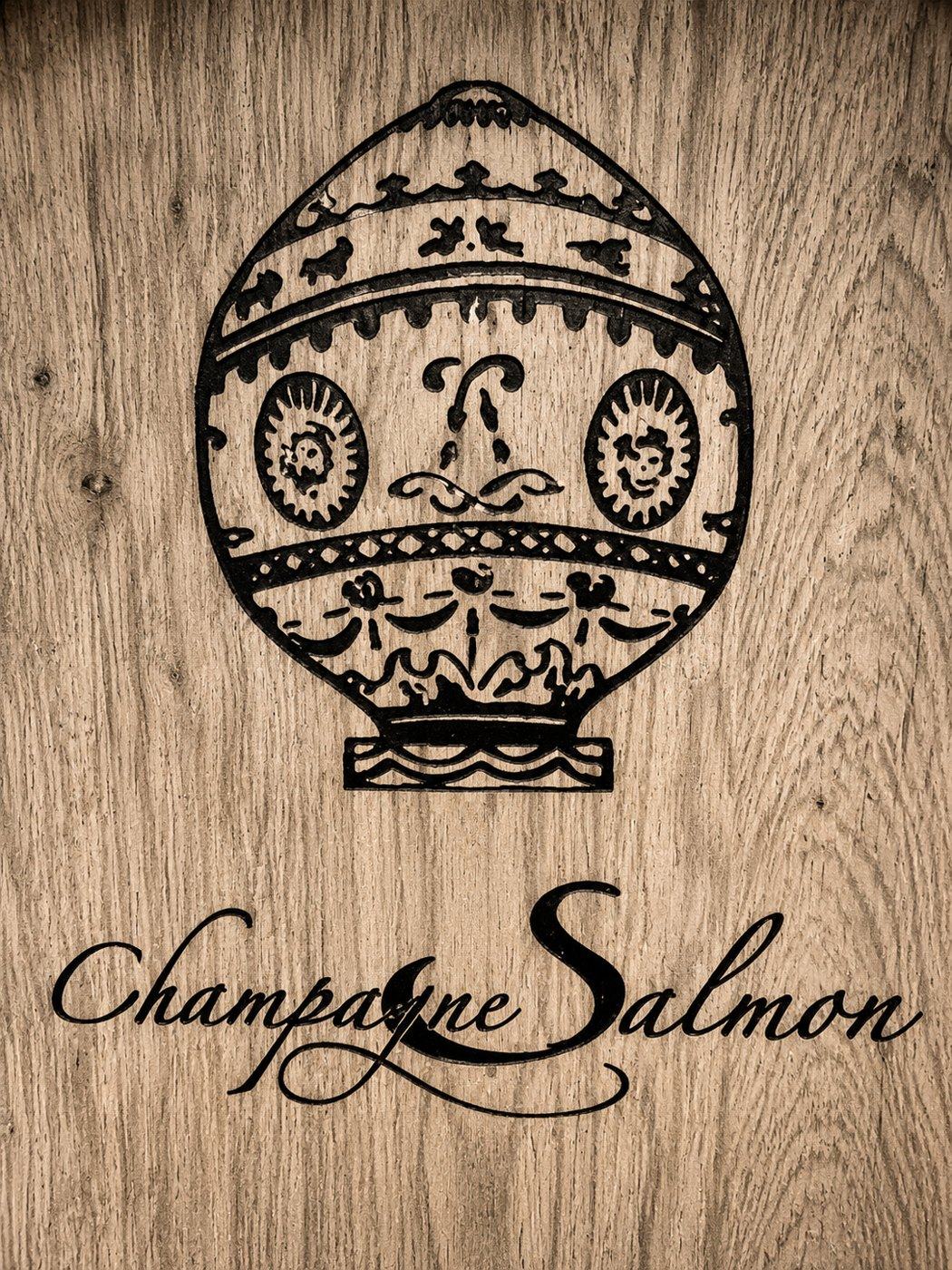 The Champagne Salmon crest, a Montgolfier balloon, branded into an oak barrel head