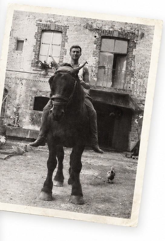 A faded 1954 photograph of Jacques Vazart astride a draught horse in the courtyard at Chouilly, a duck at its feet